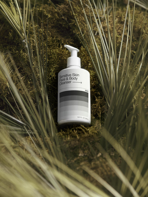 White bottle with black text on a green natural background