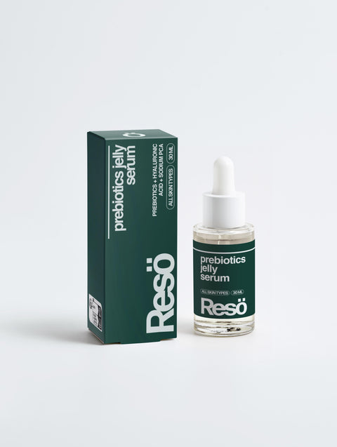 A dark green RESÖ box and matching dropper bottle labeled Bioactive Prebiotics Jelly Serum are displayed side by side on a white background, emphasizing skin barrier support and hydration benefits on the packaging.