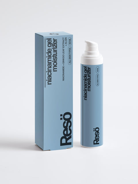 A blue bottle of RESÖ Niacinamide Gel Moisturiser sits beside its matching box, both designed for all skin types. The sleek packaging features minimalist black and white text highlighting its hydrating benefits.