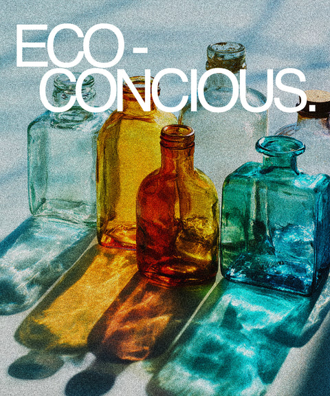 Colorful glass bottles on a textured surface with 'ECO-CONCIOUS.' text.