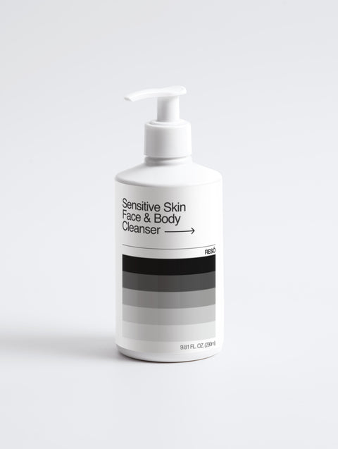 White bottle of sensitive skin face and body cleanser on a white background